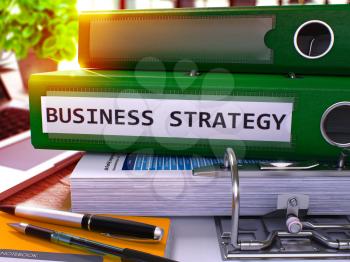 Business Strategy - Green Office Folder on Background of Working Table with Stationery and Laptop. Business Strategy Business Concept on Blurred Background. Business Strategy Toned Image. 3D.