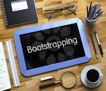 Bootstrapping - Text on Small Chalkboard.Top View of Office Desk with Stationery and Blue Small Chalkboard with Business Concept - Bootstrapping. 3d Rendering.
