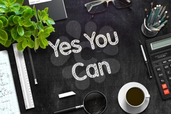 Yes You Can. Business Concept Handwritten on Black Chalkboard. Top View Composition with Chalkboard and Office Supplies. 3d Rendering. Toned Illustration.