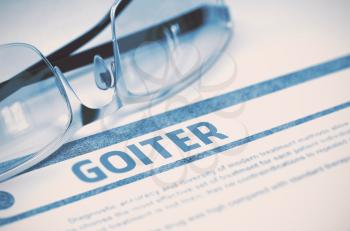 Goiter - Medical Concept on Blue Background with Blurred Text and Composition of Eyeglasses. 3D Rendering.