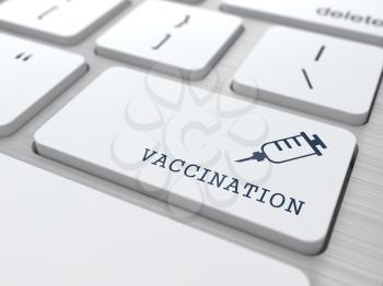 Vaccination Word with Syringe Icon -  Button of White Modern Computer Keyboard. Medical Concept.