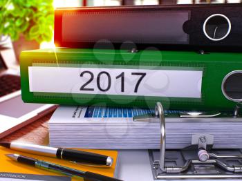 2017 - Green Ring Binder on Office Desktop with Office Supplies and Modern Laptop. 2017 Business Concept on Blurred Background. 2017 - Toned Illustration. 3D Render.
