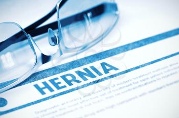 Hernia - Medicine Concept with Blurred Text and Glasses on Blue Background. Selective Focus. 3D Rendering.