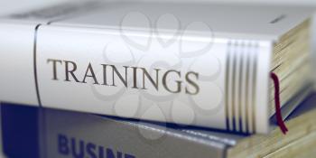 Trainings. Book Title on the Spine. Trainings - Business Book Title. Close-up of a Book with the Title on Spine Trainings. Toned Image with Selective focus. 3D Illustration.