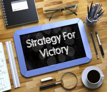 Strategy For Victory - Blue Small Chalkboard with Hand Drawn Text and Stationery on Office Desk. Top View. Strategy For Victory Concept on Small Chalkboard. 3d Rendering.