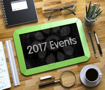 2017 Events Concept on Small Chalkboard. Business Concept - 2017 Events Handwritten on Green Small Chalkboard. Top View Composition with Chalkboard and Office Supplies on Office Desk. 3d Rendering.