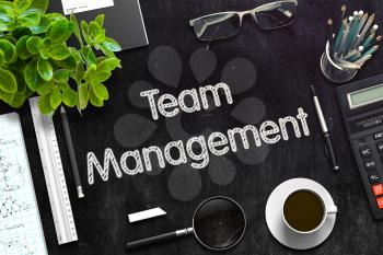 Team Management Handwritten on Black Chalkboard. Top View Composition with Black Chalkboard with Office Supplies Around. 3d Rendering. Toned Illustration.