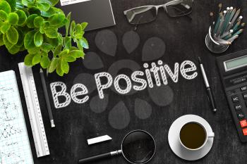 Be Positive. Business Concept Handwritten on Black Chalkboard. Top View Composition with Chalkboard and Office Supplies. 3d Rendering. Toned Image.