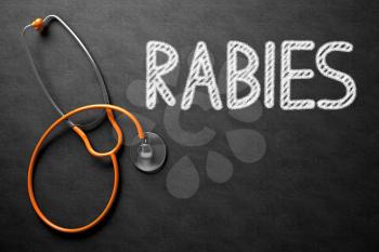 Medical Concept: Rabies -  Black Chalkboard with Hand Drawn Text and Orange Stethoscope. Top View. Medical Concept: Rabies on Black Chalkboard. 3D Rendering.