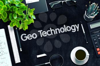 Geo Technology. Business Concept Handwritten on Black Chalkboard. Top View Composition with Chalkboard and Office Supplies. 3d Rendering. Toned Image.