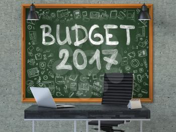 Green Chalkboard on the Gray Concrete Wall in the Interior of a Modern Office with Hand Drawn Budget 2017. Business Concept with Doodle Style Elements. 3D.