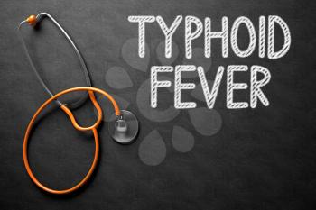 Medical Concept: Typhoid Fever -  Black Chalkboard with Hand Drawn Text and Orange Stethoscope. Top View. Medical Concept: Black Chalkboard with Typhoid Fever. 3D Rendering.
