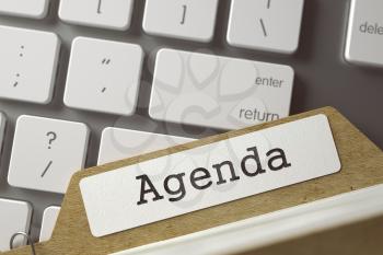 Agenda written on  Card File Lays on Modern Metallic Keyboard. Archive Concept. Closeup View. Blurred Toned Image. 3D Rendering.