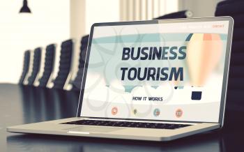 Business Tourism - Landing Page with Inscription on Laptop Screen on Background of Comfortable Meeting Hall in Modern Office. Closeup View. Blurred Image. Selective focus. 3D Render.