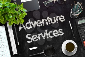 Business Concept - Adventure Services Handwritten on Black Chalkboard. Top View Composition with Chalkboard and Office Supplies on Office Desk. 3d Rendering. Toned Image.
