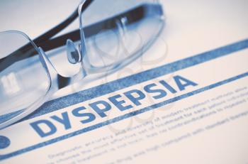 Diagnosis - Dyspepsia. Medical Concept with Blurred Text and Eyeglasses on Blue Background. Selective Focus. 3D Rendering.