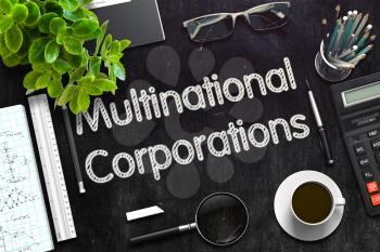 Multinational Corporations. Business Concept Handwritten on Black Chalkboard. Top View Composition with Chalkboard and Office Supplies. 3d Rendering. Toned Illustration.