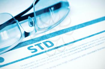 Diagnosis - STD - Sexually Transmitted Disease. Medical Concept with Blurred Text and Spectacles on Blue Background. Selective Focus. 3D Rendering.