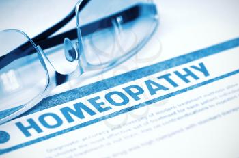 Homeopathy - Medicine Concept with Blurred Text and Eyeglasses on Blue Background. Selective Focus. 3D Rendering.