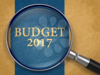 Budget 2017 through Lens on Old Paper with Dark Blue Vertical Line Background. 3D Render.