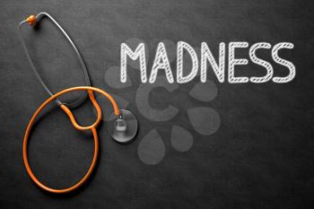 Medical Concept: Madness - Text on Black Chalkboard with Orange Stethoscope. Black Chalkboard with Madness - Medical Concept. 3D Rendering.