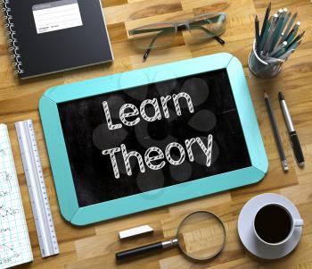 Learn Theory - Text on Small Chalkboard.Learn Theory Handwritten on Mint Chalkboard. Top View Composition with Small Chalkboard on Working Table with Office Supplies Around. 3d Rendering.