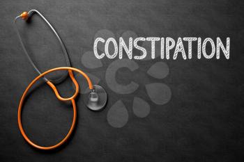 Medical Concept: Constipation on Black Chalkboard. Constipation Handwritten Medical Concept on Chalkboard. Top View Composition with Black Chalkboard and Orange Stethoscope on it. 3D Rendering.
