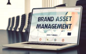 Brand Asset Management - Landing Page with Inscription on Mobile Computer Screen on Background of Comfortable Meeting Room in Modern Office. Closeup View. Toned Image. Blurred Background. 3D.