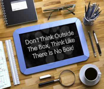 Small Chalkboard with Dont Think Outside The Box, Think Like There Is No Box. Dont Think Outside The Box, Think Like There Is No Box Handwritten on Small Chalkboard. 3d Rendering.