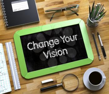 Change Your Vision - Text on Small Chalkboard.Change Your Vision Handwritten on Green Small Chalkboard. Top View of Wooden Office Desk with a Lot of Business and Office Supplies on It. 3d Rendering.