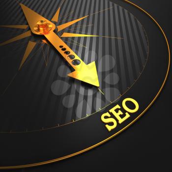 SEO - Internet Concept. Golden Compass Needle on a Black Field Pointing to the SEO Word.