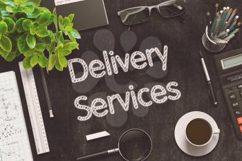Delivery Services. Business Concept Handwritten on Black Chalkboard. Top View Composition with Chalkboard and Office Supplies. 3d Rendering. Toned Illustration.
