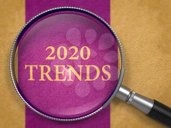 2020 Trends Concept through Magnifier or Magnifying Glass on Purpule Paper with Dark Lilac Vertical Line Background. Business Concept.