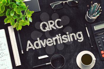 QRC Advertising. Business Concept Handwritten on Black Chalkboard. Top View Composition with Chalkboard and Office Supplies. 3d Rendering. Toned Image.