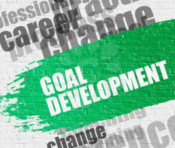 Business Education Concept: Goal Development on the White Brick Wall Background with Wordcloud Around It. Goal Development on Green Distressed Paintbrush Stripe. 