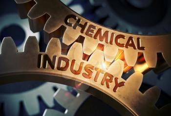 Chemical Industry - Industrial Design. Chemical Industry on the Mechanism of Golden Cogwheels with Lens Flare. 3D Rendering.