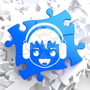 Happy Boy with Headphones Icon on Blue Puzzle. Sound, Music Concept.
