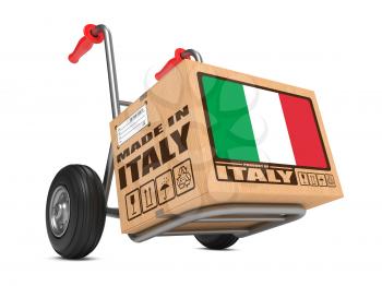 Cardboard Box with Flag of Italy and Made in Italy Slogan on Hand Truck White Background. Free Shipping Concept.