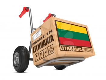 Cardboard Box with Flag of Lithuania and Made in Lithuania Slogan on Hand Truck White Background. Free Shipping Concept.