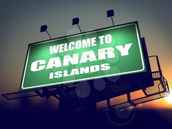Welcome to Canary Islands - Green Billboard on the Rising Sun Background.