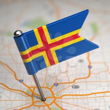 Small Flag of Aland Islands on a Map Background with Selective Focus.