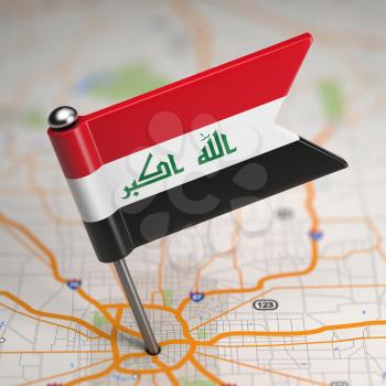 Small Flag of Iraq on a Map Background with Selective Focus.