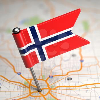 Small Flag of Norway Sticked in the Map Background with Selective Focus.