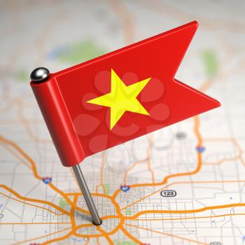 Small Flag of Vietnam Sticked in the Map Background with Selective Focus.