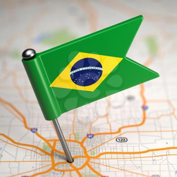 Small Flag of Brazil Sticked in the Map Background with Selective Focus.