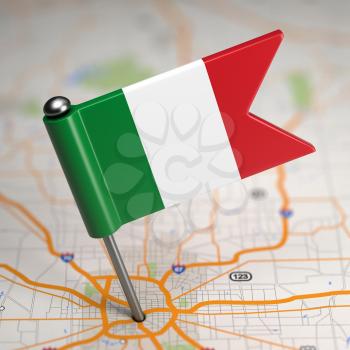 Small Flag of Italy Sticked in the Map Background with Selective Focus.