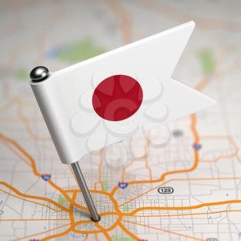 Small Flag of Japan Sticked in the Map Background with Selective Focus.