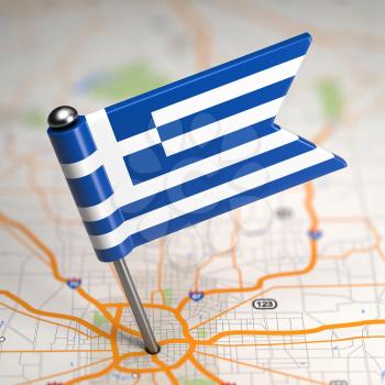 Small Flag of Hellenic Republic of Greece on a Map Background with Selective Focus.