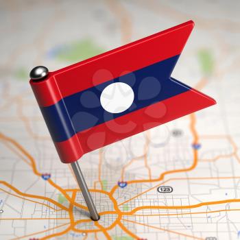 Small Flag of Lao People's Democratic Republic on a Map Background with Selective Focus.
