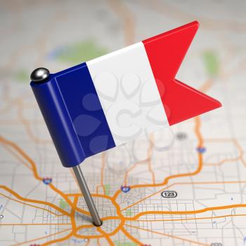 French Small Flag on a Map Background with Selective Focus.